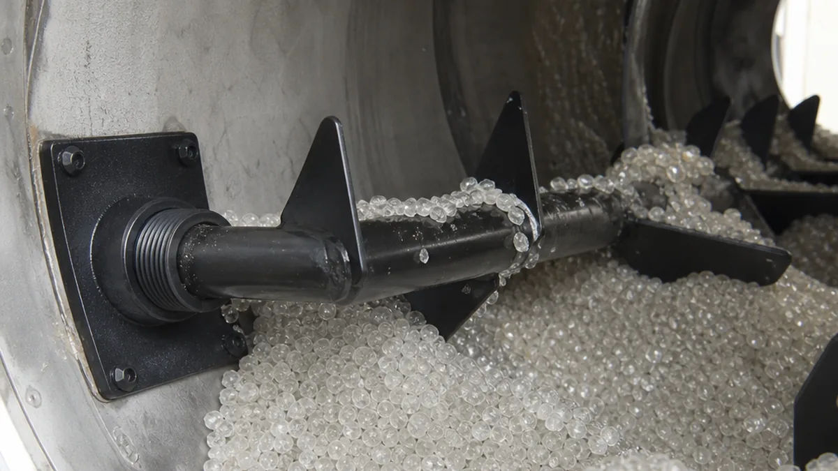 PET Crystallizer Sticking Material: Diagnosis and Correction Guide | Elant Machinery amorphous PET pellets clumping together inside an industrial rotary crystallizer drum, cross-section view, technical editorial style